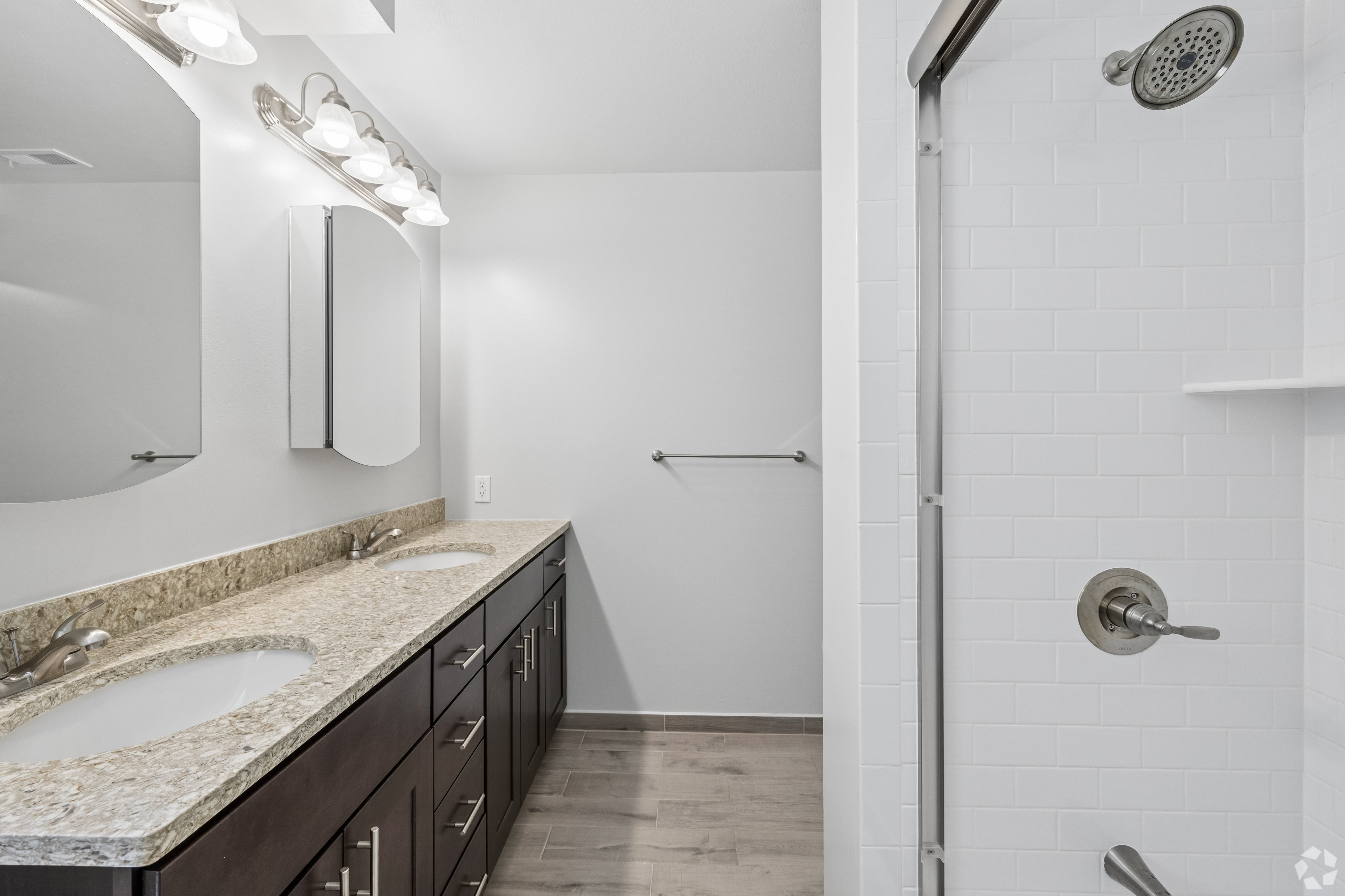A bathroom with a sink and a shower.